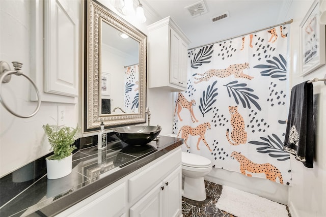 bathroom featuring toilet, visible vents, ornamental molding, and vanity