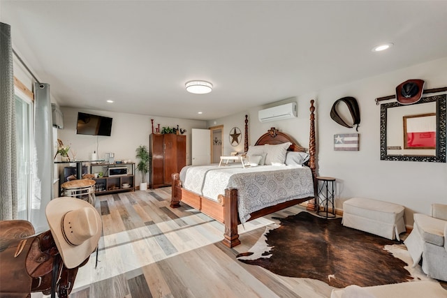 bedroom featuring multiple windows, a wall mounted AC, recessed lighting, and wood finished floors