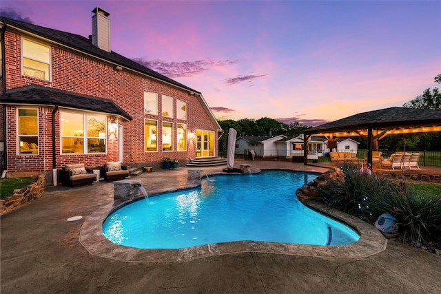 pool at dusk featuring an outdoor living space, an outdoor pool, a patio area, a gazebo, and fence