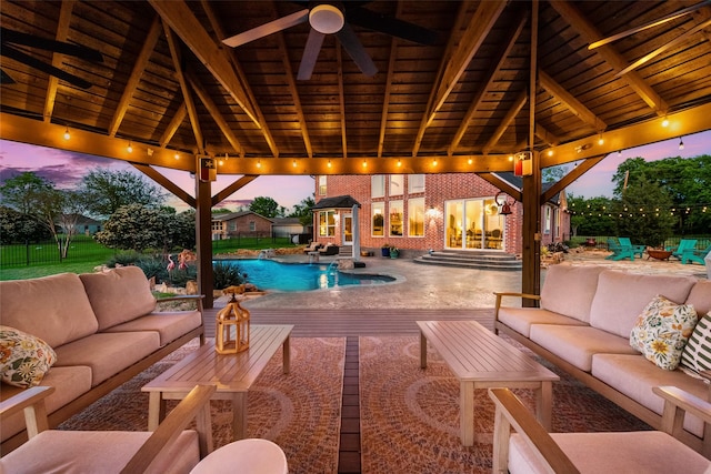 view of pool with a fenced in pool, a ceiling fan, outdoor lounge area, and a patio area