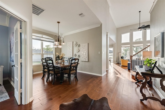 dining room featuring baseboards, visible vents, dark wood-style floors, and ceiling fan with notable chandelier