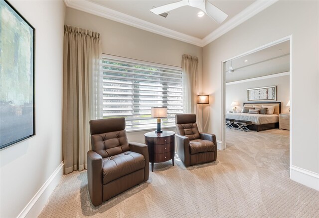 sitting room with crown molding, a ceiling fan, carpet, and baseboards