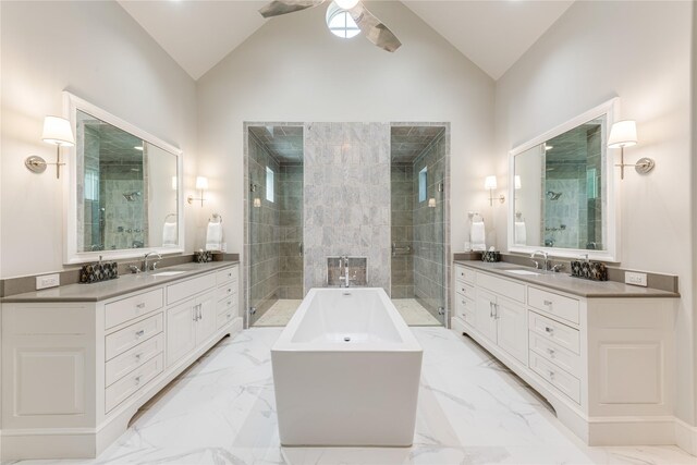 bathroom featuring a sink, marble finish floor, and lofted ceiling