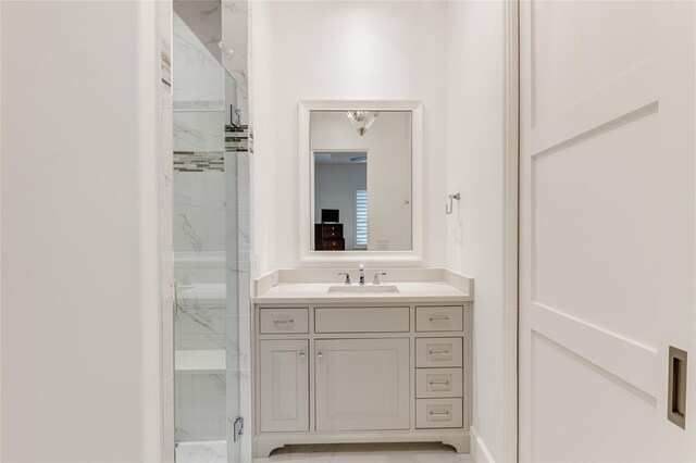 bathroom featuring a shower stall and vanity