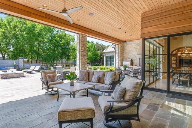 view of patio / terrace with fence, a ceiling fan, outdoor dining space, and an outdoor living space with a fire pit