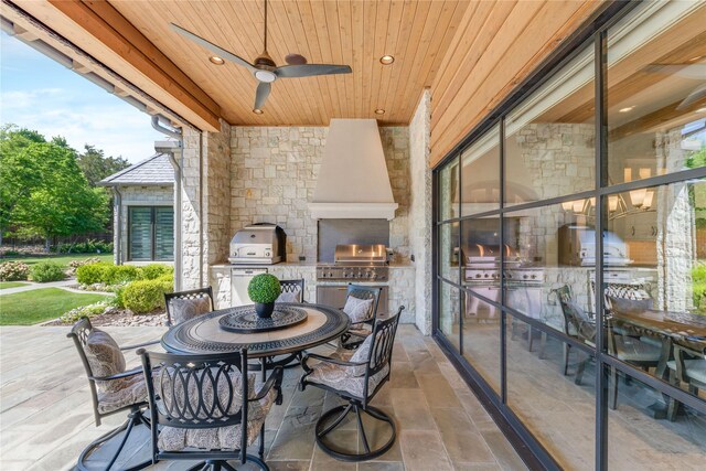 view of patio / terrace with outdoor dining area, a grill, exterior kitchen, and ceiling fan