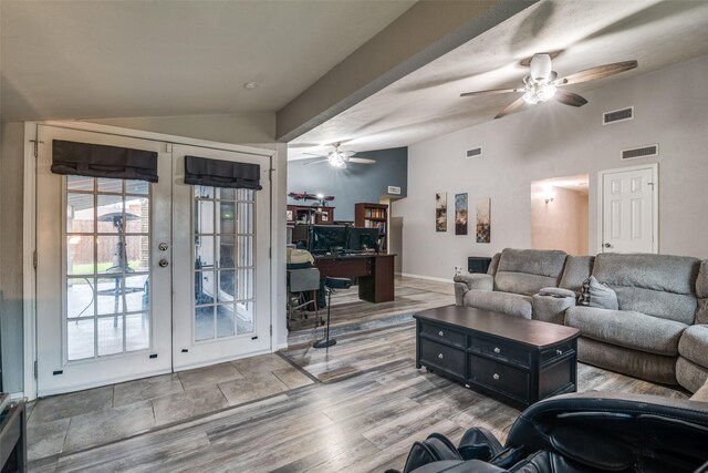 living room featuring ceiling fan, vaulted ceiling, french doors, and visible vents