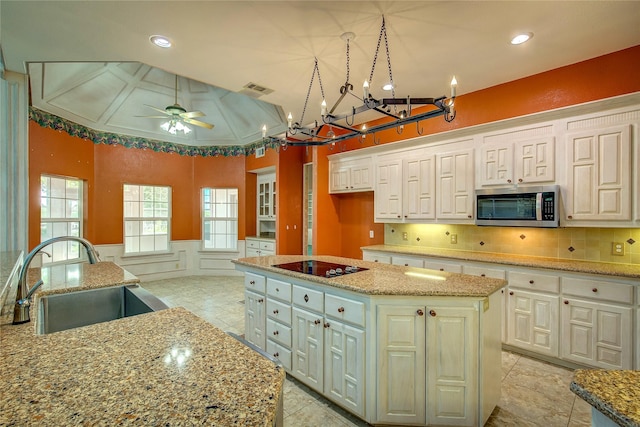 2160 W Fm 550, Mclendon Chisholm, TX 75032 - kitchen featuring stainless steel microwave, a sink, a center island, black electric stovetop, and a chandelier