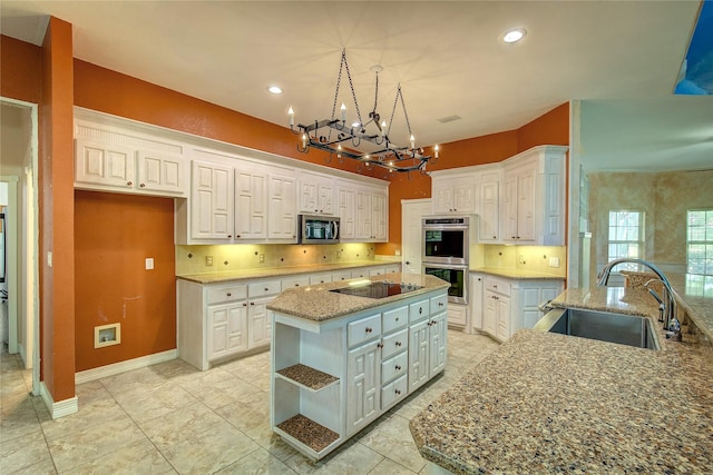 2160 W Fm 550, Mclendon Chisholm, TX 75032 - kitchen with a sink, appliances with stainless steel finishes, a center island, a chandelier, and white cabinets