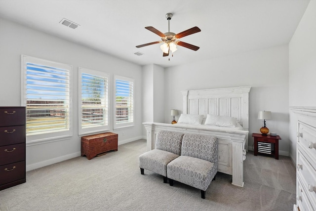 carpeted bedroom with visible vents, baseboards, and ceiling fan