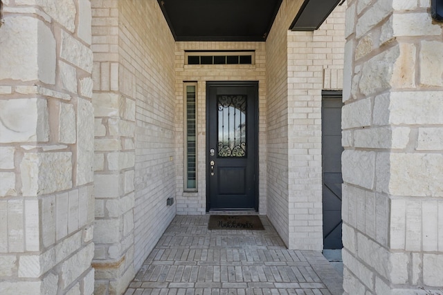 doorway to property with stone siding