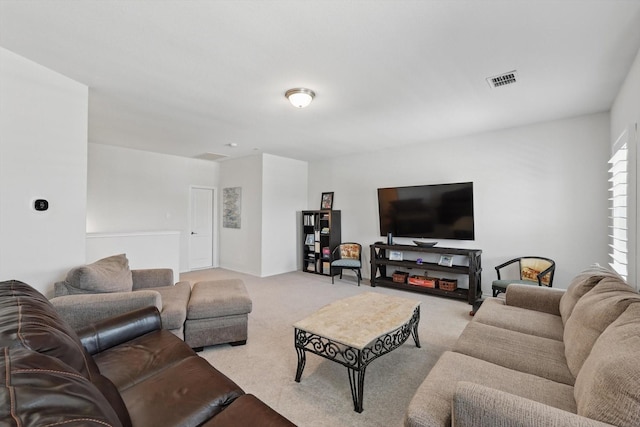 living area with light colored carpet and visible vents