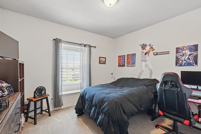 bedroom featuring light colored carpet and baseboards
