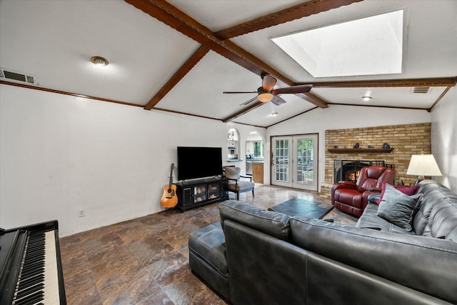 9008 Flicker Ln, Dallas, TX 75238 - living area with stone finish floors, a skylight, a fireplace, and ceiling fan