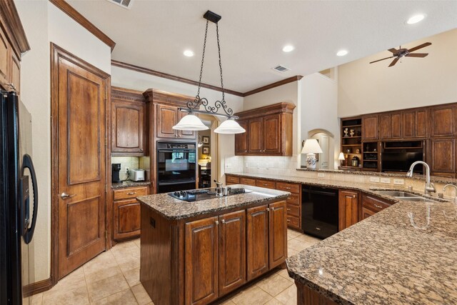 kitchen with visible vents, decorative backsplash, a sink, dark stone countertops, and black appliances