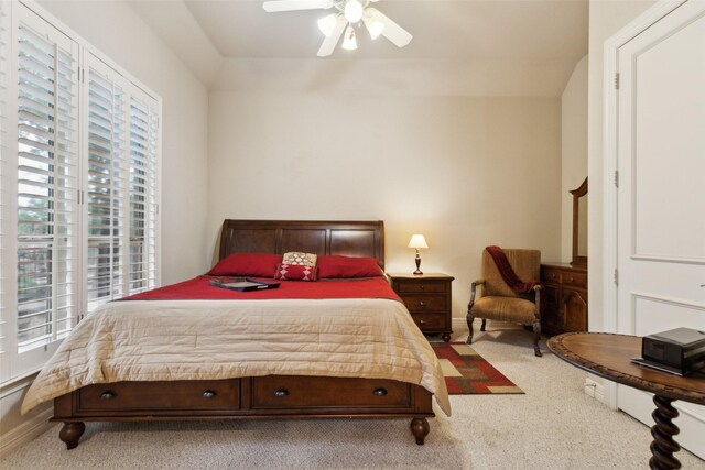 carpeted bedroom featuring ceiling fan, multiple windows, and baseboards