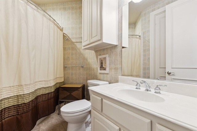 bathroom featuring vanity, tile patterned floors, toilet, and curtained shower