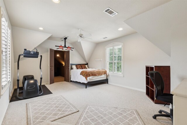 carpeted bedroom with baseboards, ceiling fan, vaulted ceiling, and visible vents
