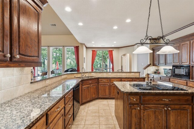 kitchen with visible vents, arched walkways, tasteful backsplash, a sink, and black appliances