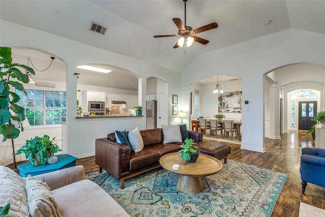 5000 Stonecrest Dr, Mckinney, TX 75071 - living area with arched walkways, vaulted ceiling, wood finished floors, a ceiling fan, and baseboards