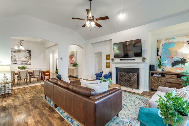 5000 Stonecrest Dr, Mckinney, TX 75071 - living area with lofted ceiling, ceiling fan, arched walkways, wood finished floors, and a fireplace with flush hearth