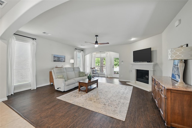400 Sterling Rdg, Lantana, TX 76226 - living area with wood finished floors, a ceiling fan, visible vents, arched walkways, and a fireplace with raised hearth