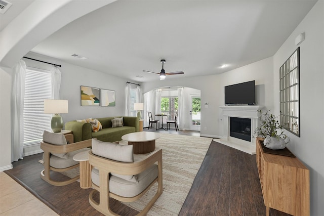 400 Sterling Rdg, Lantana, TX 76226 - living area with ceiling fan, visible vents, arched walkways, and a fireplace with flush hearth