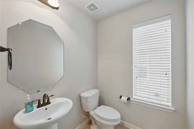 400 Sterling Rdg, Lantana, TX 76226 - bathroom with a sink, toilet, baseboards, and visible vents