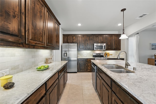 400 Sterling Rdg, Lantana, TX 76226 - kitchen featuring hanging light fixtures, a sink, visible vents, backsplash, and appliances with stainless steel finishes