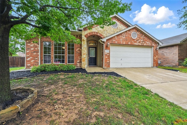 5801 Red Drum Dr, Fort Worth, TX 76179 - traditional home featuring an attached garage, driveway, brick siding, and stone siding
