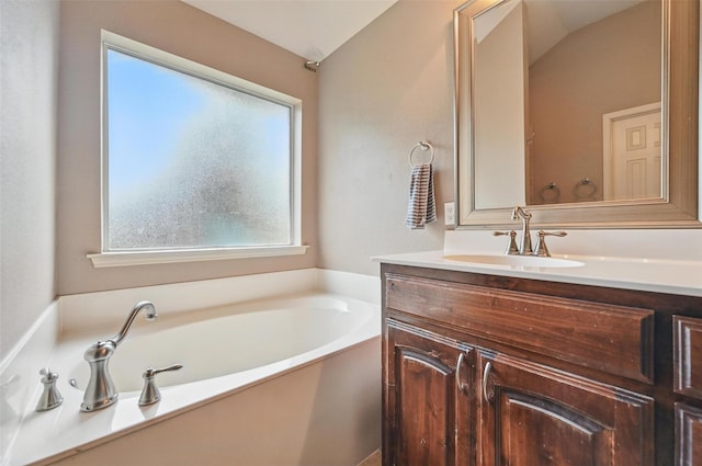 full bath with vanity and a bath