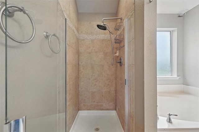 full bath with a garden tub and a stall shower