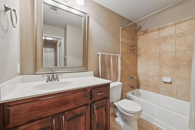 bathroom with vanity, a textured wall, toilet, tile patterned floors, and shower / bath combination
