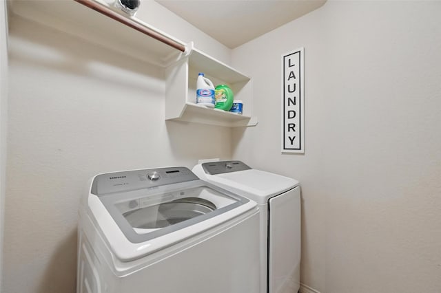 clothes washing area featuring laundry area and washing machine and dryer