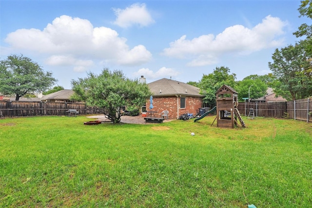 view of yard with a playground and a fenced backyard