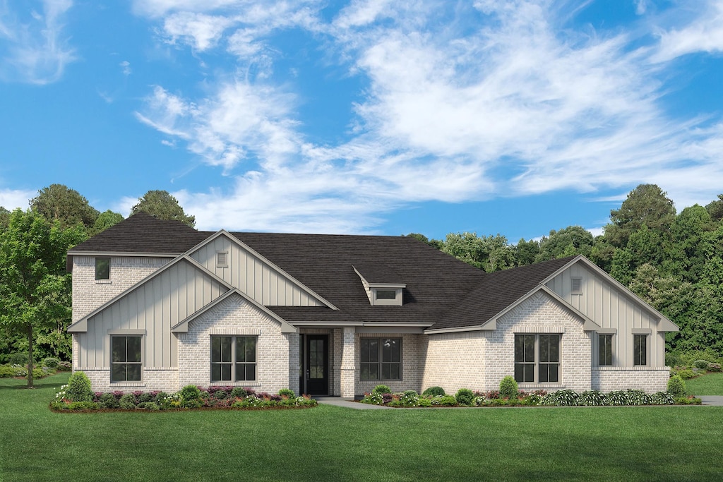 modern inspired farmhouse featuring board and batten siding, brick siding, and a front yard