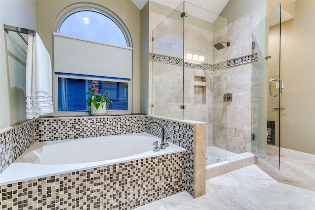 full bath with lofted ceiling, a garden tub, and a stall shower