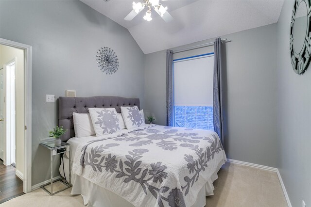 bedroom featuring baseboards, ceiling fan, and vaulted ceiling
