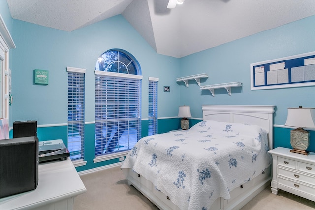 living room featuring carpet floors, ceiling fan, and lofted ceiling