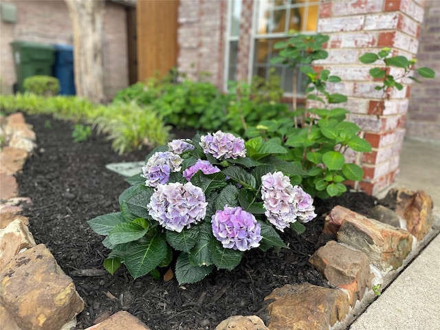 details featuring fence and brick siding