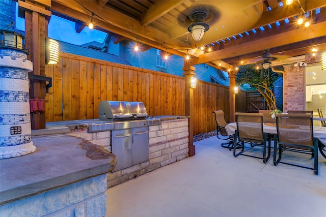 view of patio / terrace featuring an outdoor kitchen, a ceiling fan, outdoor dining area, and a fenced backyard