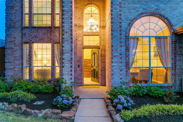 view of exterior entry with brick siding