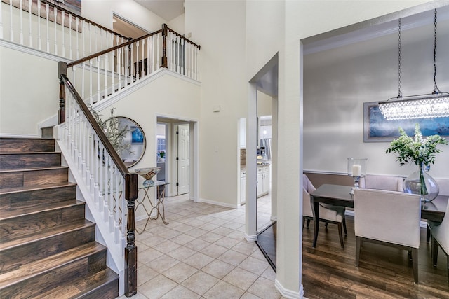 dining space with baseboards, ornamental molding, and wood finished floors
