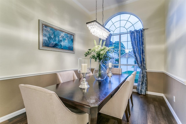 dining space with baseboards, ornamental molding, and wood finished floors