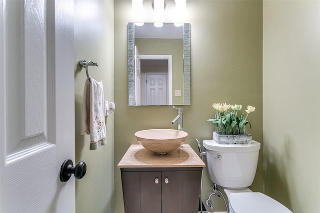 bathroom featuring toilet and vanity