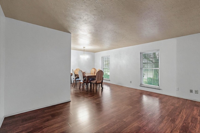 1907 Rambling Ridge Ln, Carrollton, TX 75007 - dining space with a textured ceiling and dark wood-style flooring