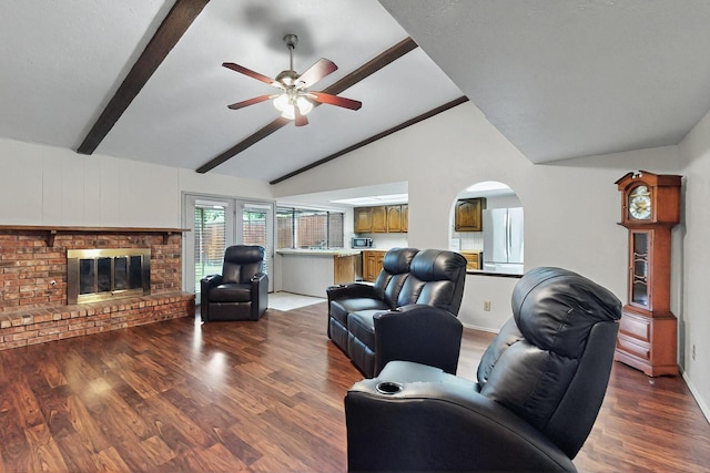 1907 Rambling Ridge Ln, Carrollton, TX 75007 - living area with a ceiling fan, a brick fireplace, wood finished floors, vaulted ceiling with beams, and arched walkways
