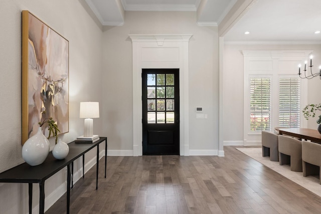 foyer entrance featuring recessed lighting, baseboards, ornamental molding, a chandelier, and wood finished floors