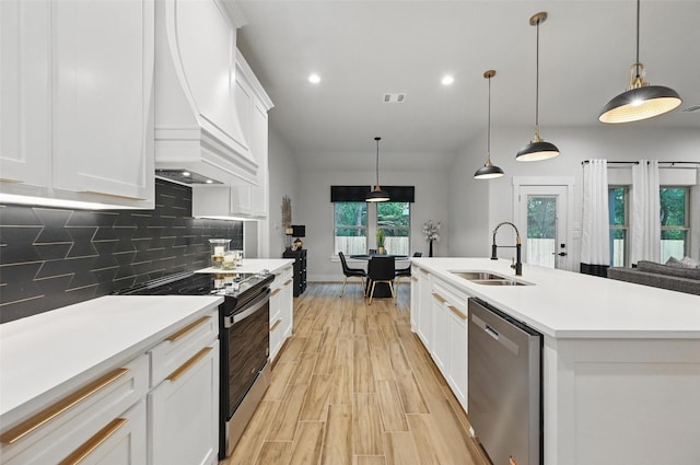 kitchen with light countertops, electric range oven, custom range hood, a sink, and dishwasher