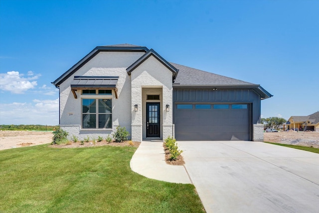 view of front of property featuring board and batten siding, driveway, a garage, brick siding, and a front lawn